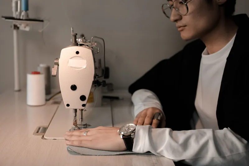 Sastre cosiendo una pieza en máquina